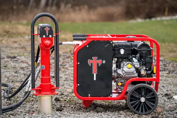 Titan hydraulic post driver and power pack in the field